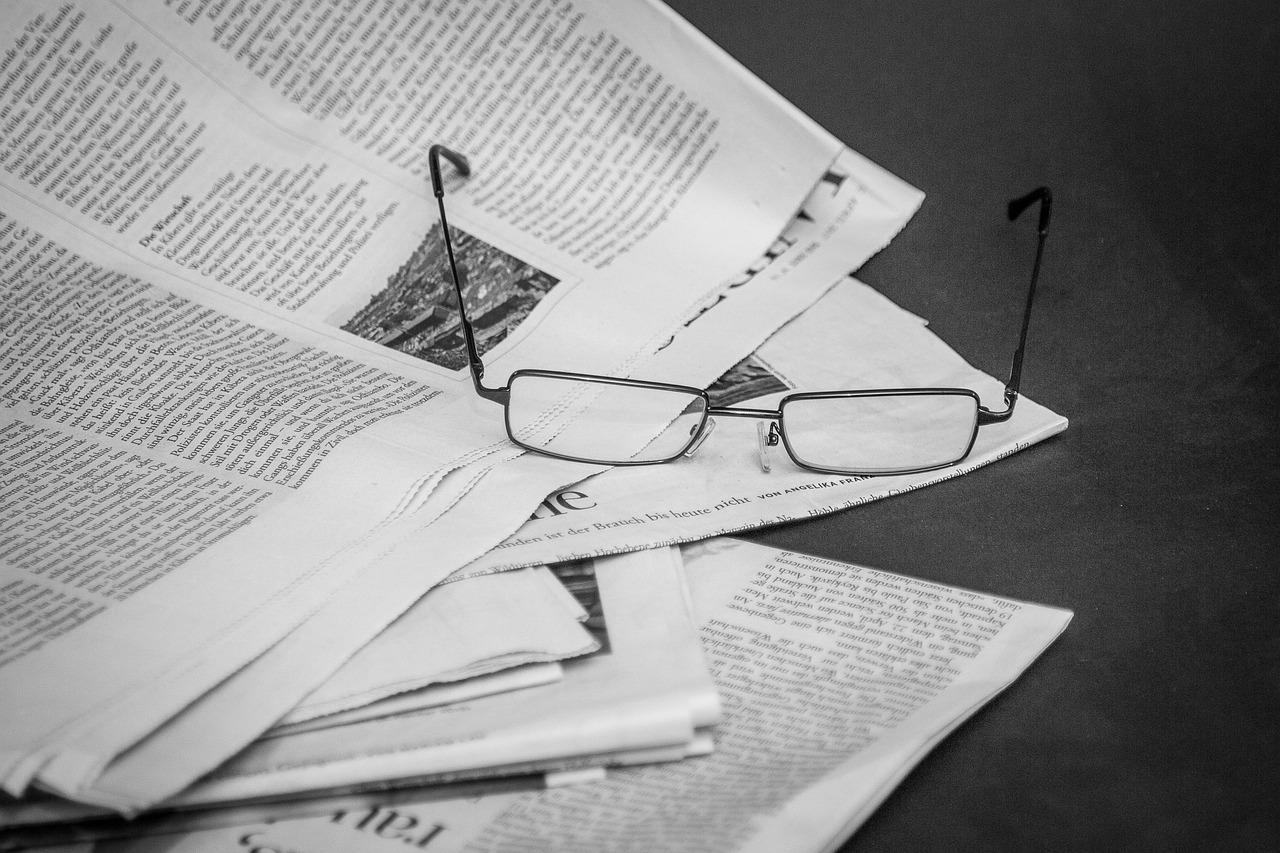 Newspaper representing compliance documentation and information flow